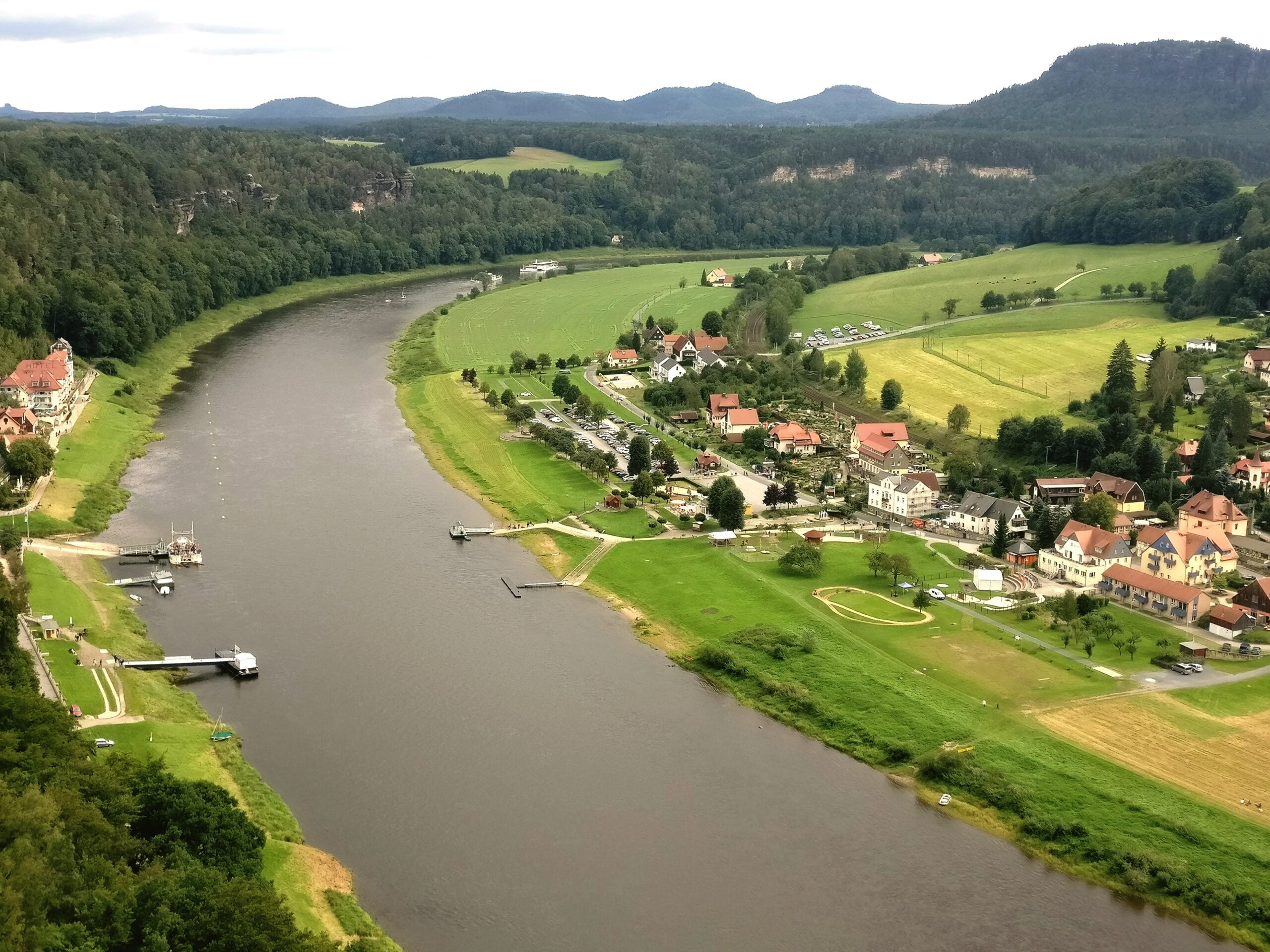 high-angle-view-houses-field-against-sky